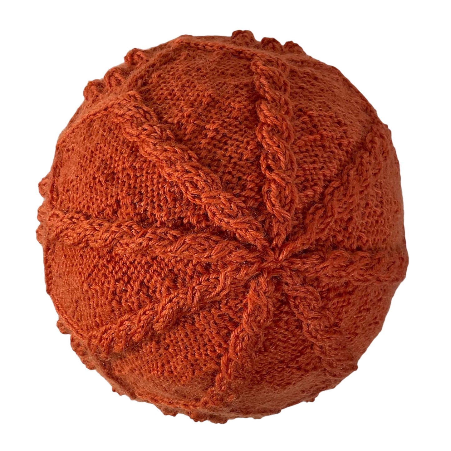hand knitted cable and bobble hat in burnt orange