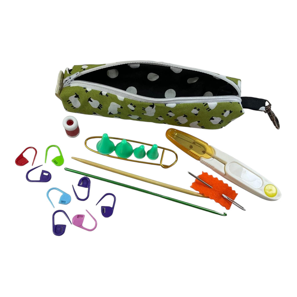 Knitting and crochet travel notions kit filled with accessories,  handy clip on knit bag travel kit, stitch markers, travel scissors,