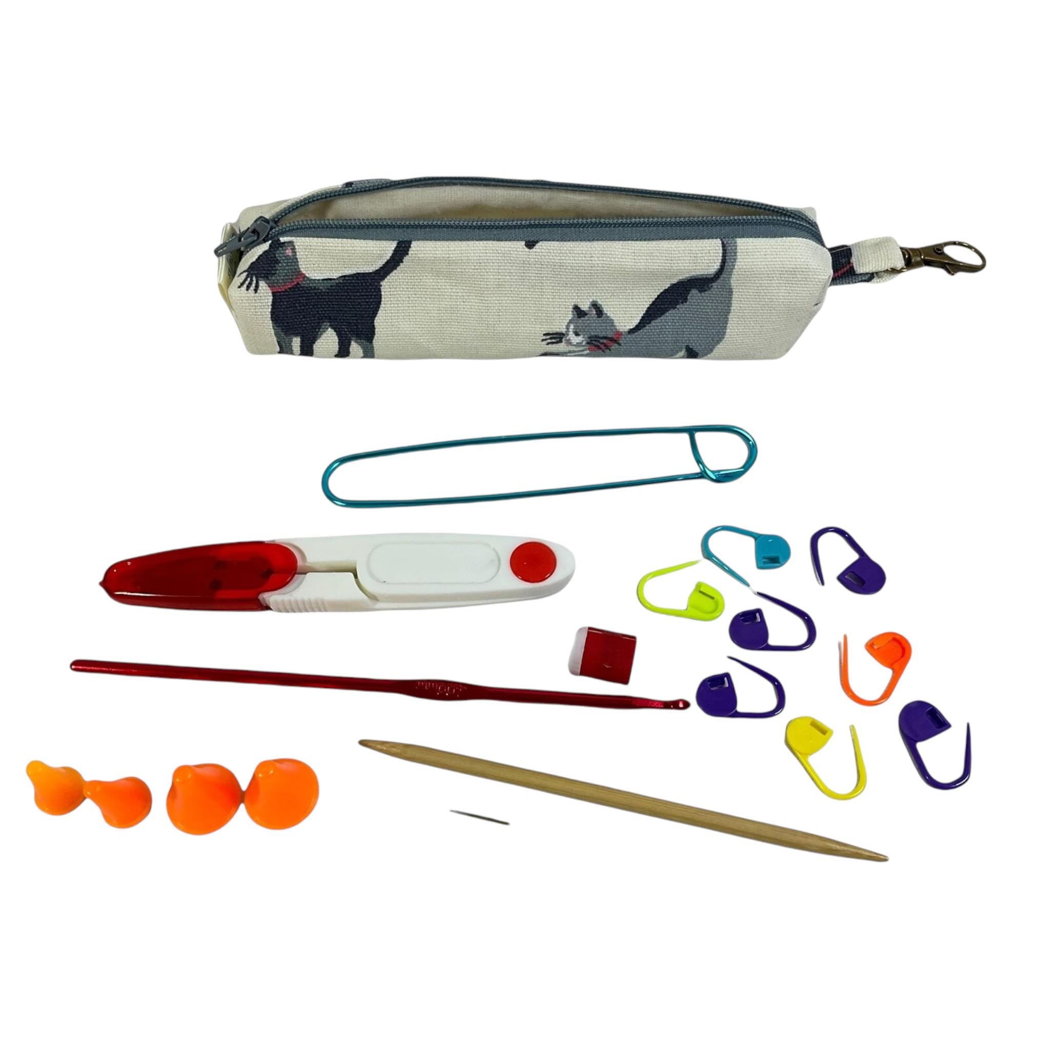 Knitting and crochet travel notions kit filled with accessories,  handy clip on knit bag travel kit, stitch markers, travel scissors,