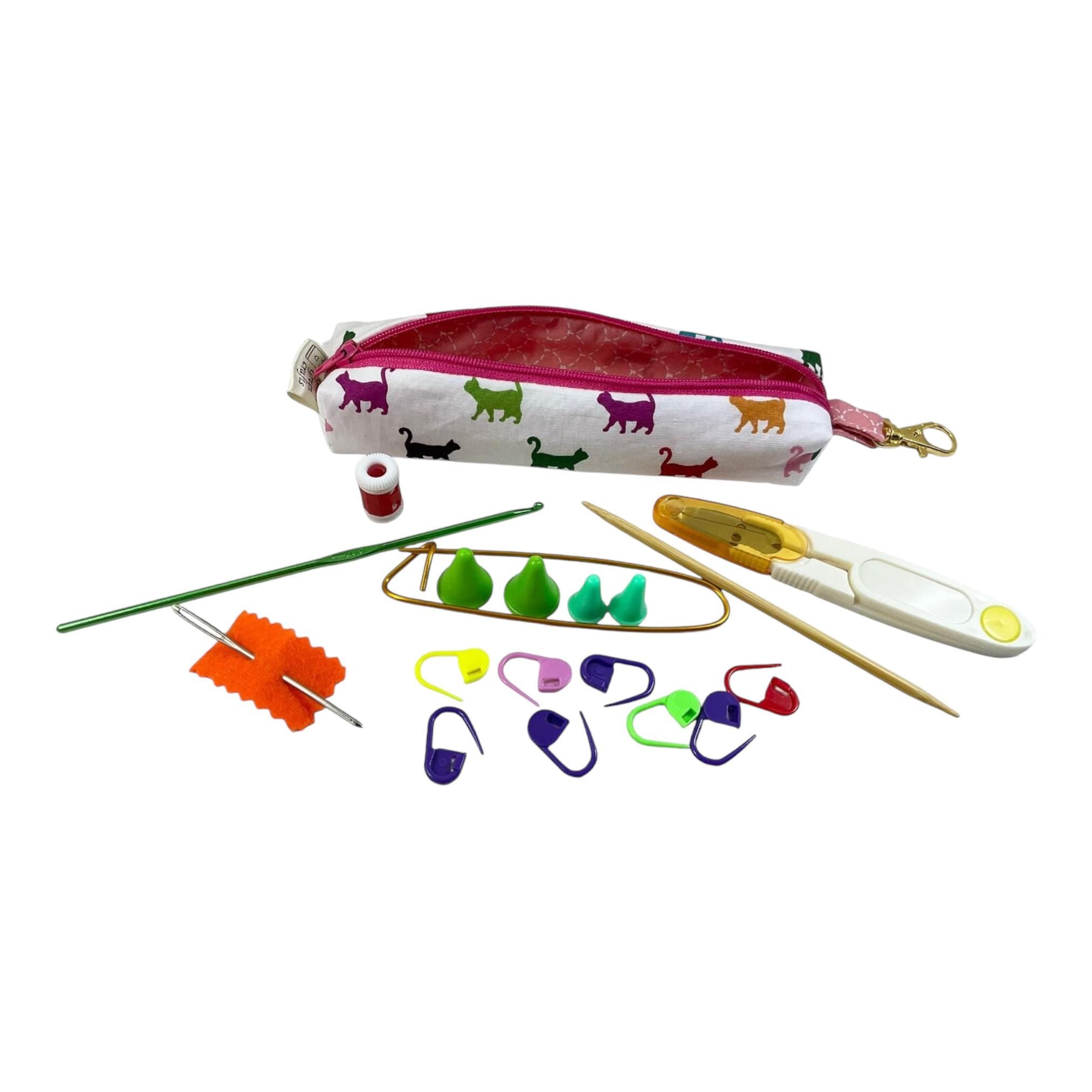 Knitting and crochet travel notions kit filled with accessories,  handy clip on knit bag travel kit, stitch markers, travel scissors,