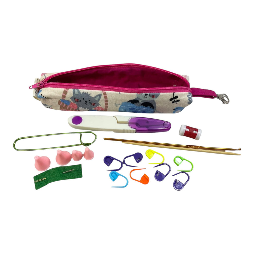 Knitting and crochet travel notions kit filled with accessories,  handy clip on knit bag travel kit, stitch markers, travel scissors,