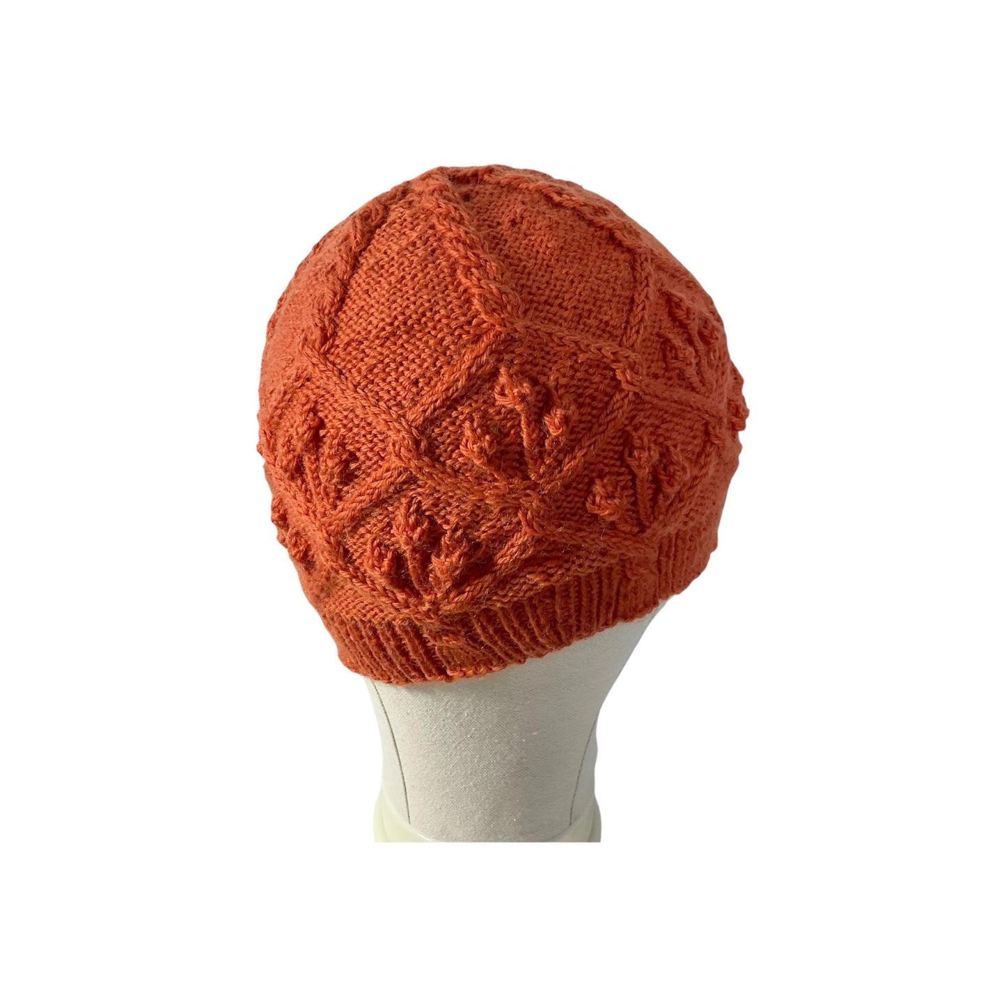 hand knitted cable and bobble hat in burnt orange
