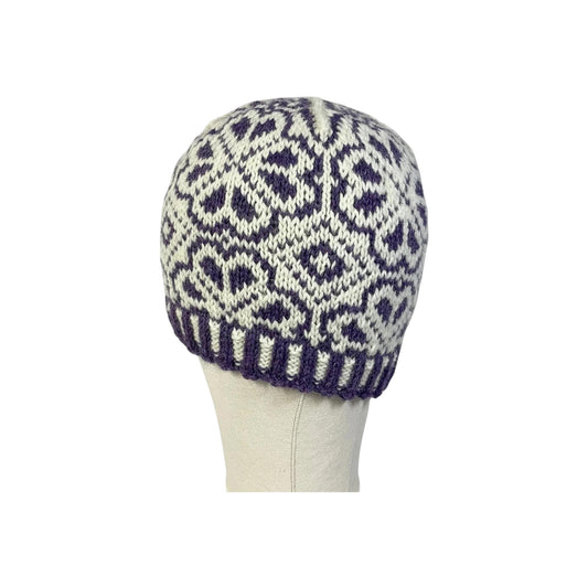 hand knit hat with white and purple floral motif