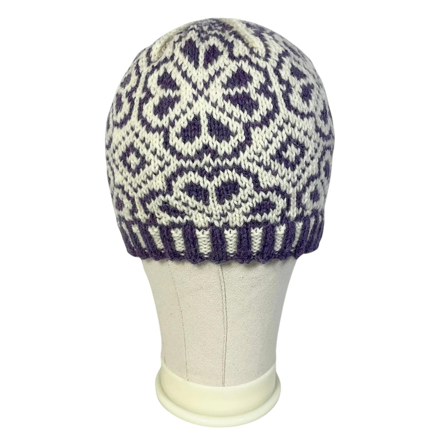 hand knit hat with white and purple floral motif