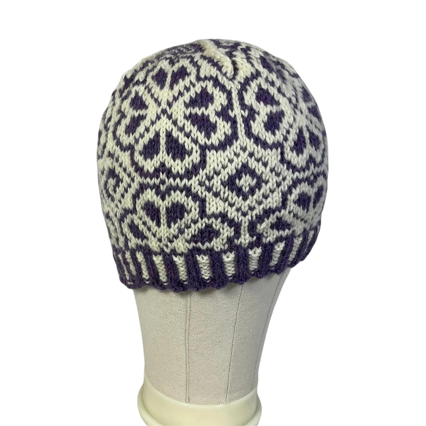 hand knit hat with white and purple floral motif