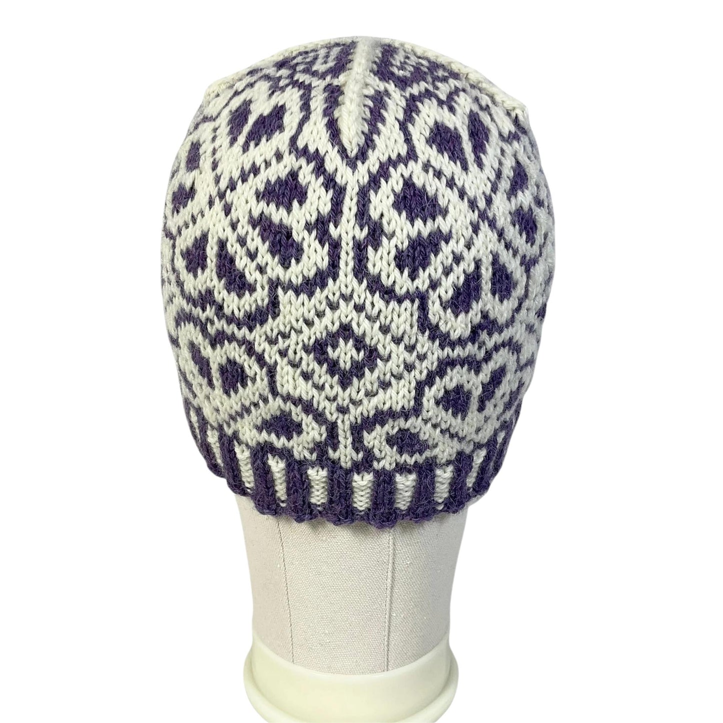 hand knit hat with white and purple floral motif