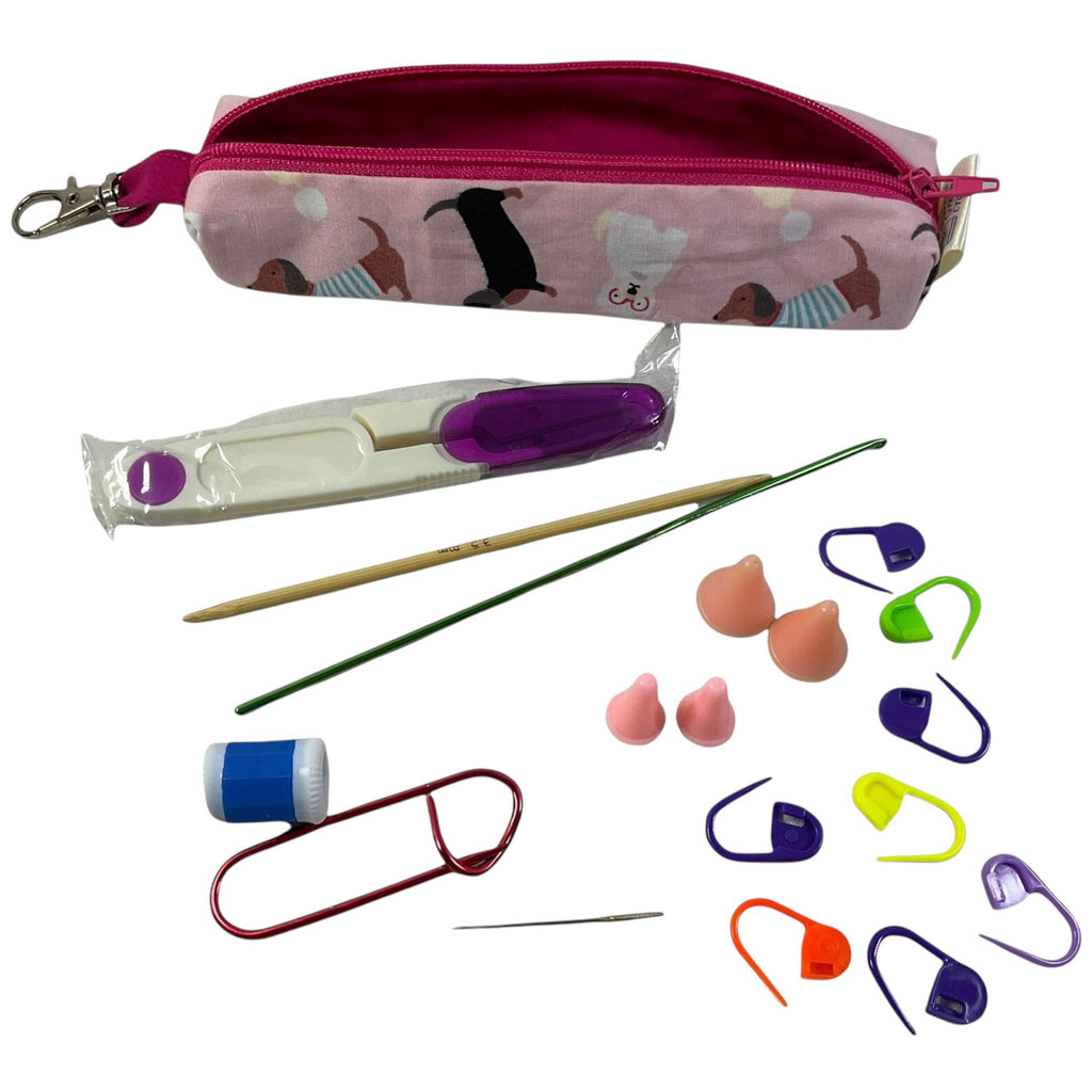 Knitting and crochet travel notions kit filled with accessories,  handy clip on knit bag travel kit, stitch markers, travel scissors,